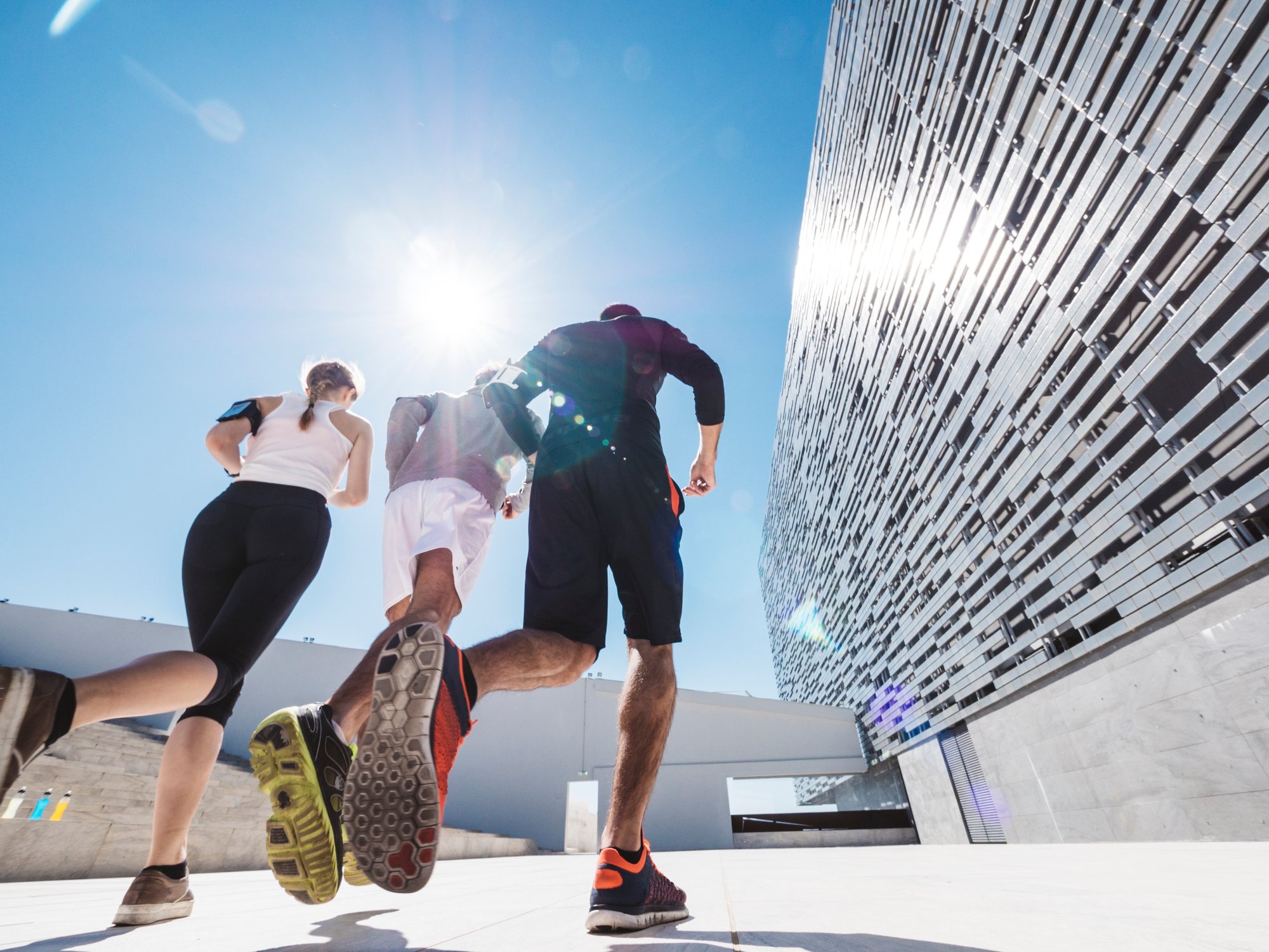 three-friends-athletes-jogging-in-a-modern-buildin-2024-09-16-13-51-32-utc